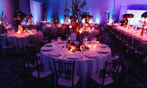 decorated-wedding-hall-with-candles-round-tables-centerpieces