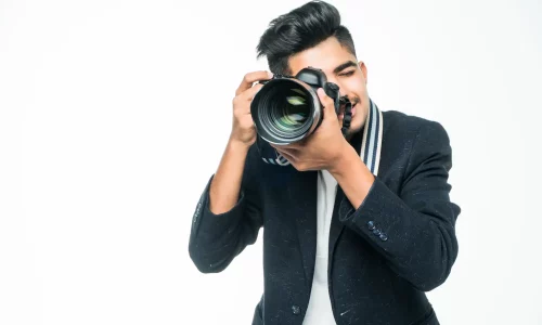 young-asian-man-with-camera-isolated-white-background-photographer-concept